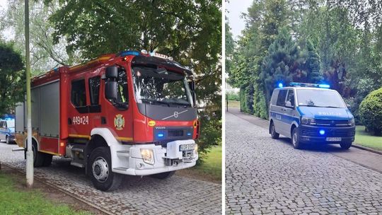 zdjęcie przedstawia samochód straży pożarnej i policji stojący na jezdni