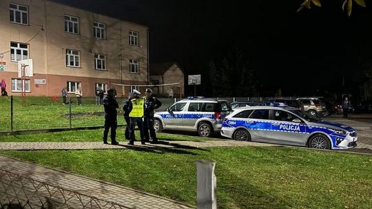 policjanci przed budynkiem szkoły w Łużnej