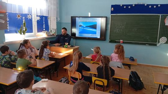 zdjęcie przedstawia klasę z uczniami i policjantem