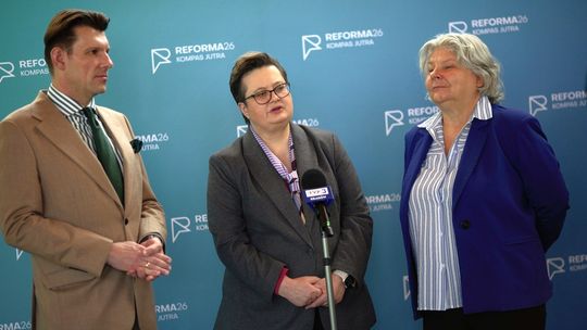 zdjęcie przedstawia dwie kobiety i mężczyznę przed mikrofonem