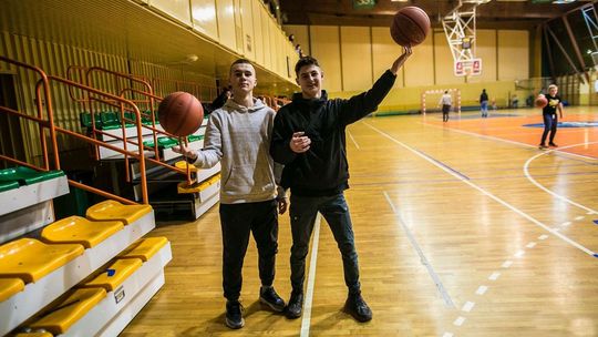 Dwóch chłopaków z piłkami do koszykówki kibice MKS-u Gorlice po meczu koszykówki w hali OSiR w Gorlicach