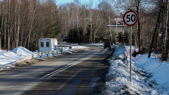 zdjęcie przedstawia samochód jadący po jezdni na moście