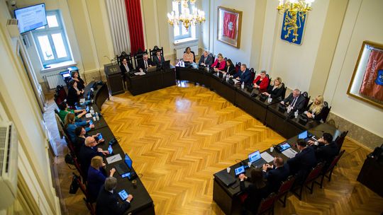 zdjęcie przedstawia dużą salę, na której są stoły a przy nim siedzą dorosłe osoby, widok z góry