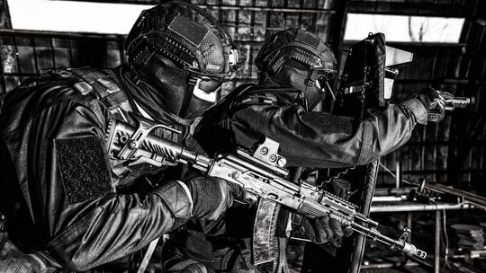 zdjęcie przedstawia policjantów w kominiarkach i z bronią