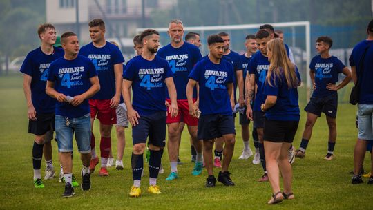 mężczyźni w jednolitych koszulkach świętujący awans do 4. ligi rozgrywek piłki nożnej w Bieczu