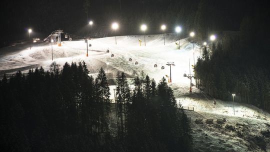 zdjęcie przedstawia oświetlony stok narciarski