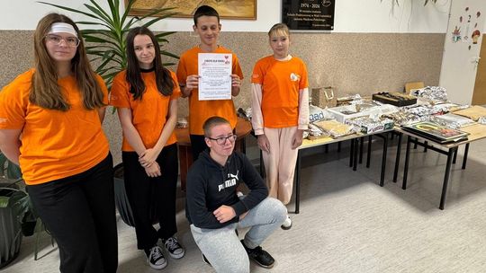 zdjęcie przedstawia dzieci w pomarańczowych koszulkach