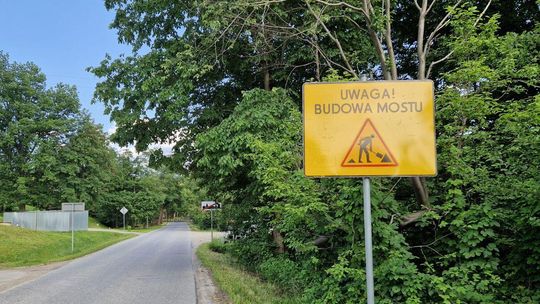 Zdjęcie przedstawia znak drogowy z budową mostu