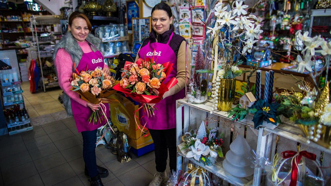 Zdjęcie przedstawia dwie kobiety z kwiatami