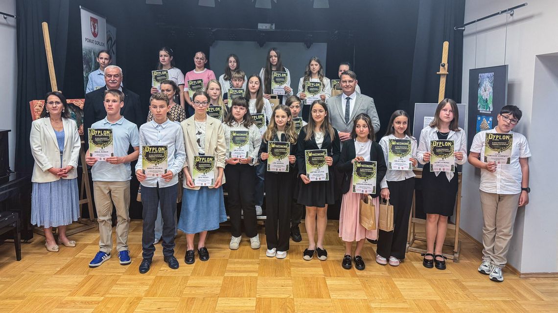 zdjęcie przedstawia grupę osób trzymających dyplomy