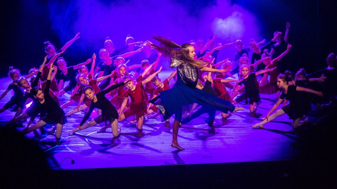 zdjęcie przedstawia dzieci tańczące na scenie