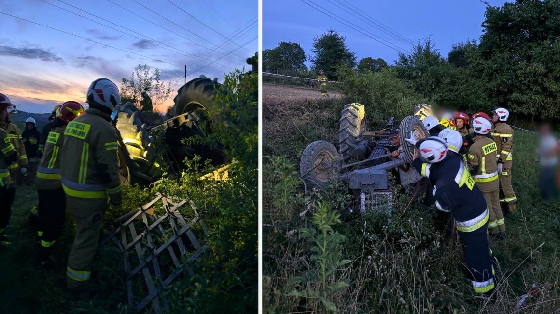 wywrócony do góry kołami traktor z bronami, obok strażacy