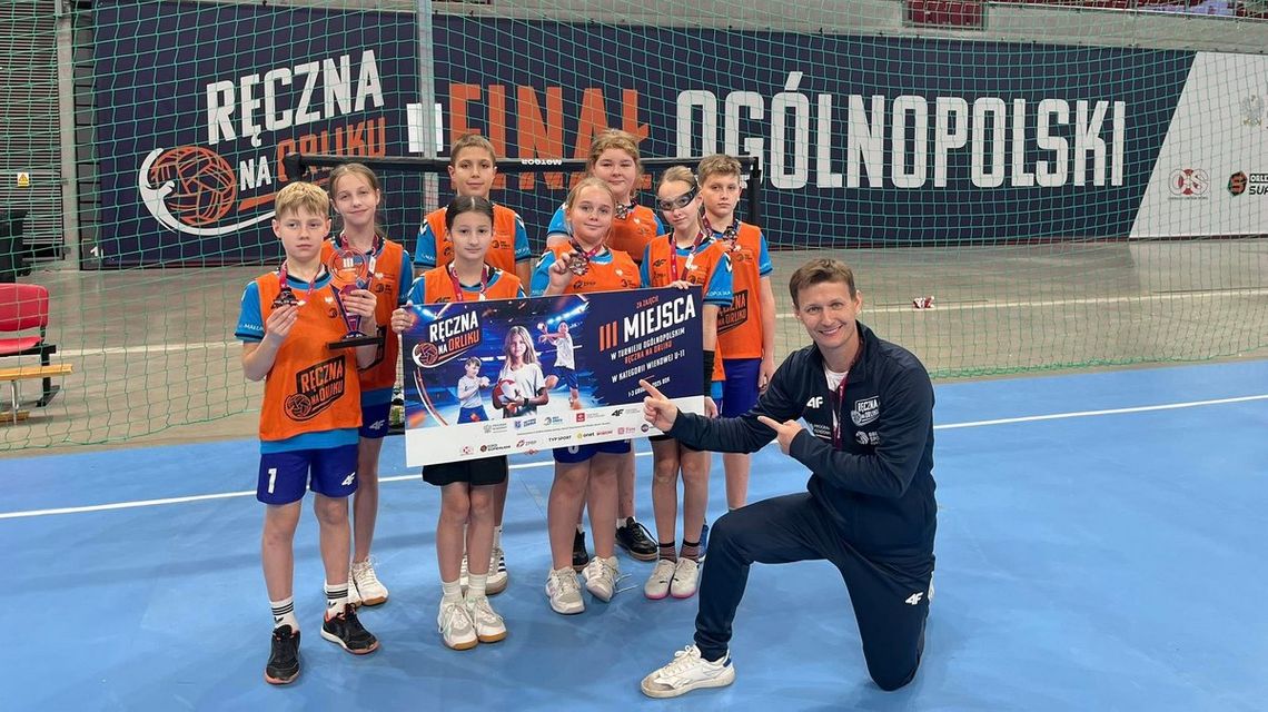 zdjęcie przedstawia dzieci z trenerem piłki ręcznej