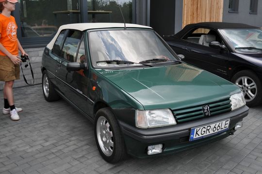 samochody i motocykle i ich kierowcy biorący udział w zlocie samochodowym