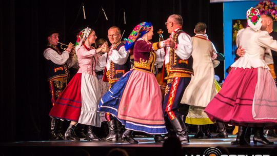 zdjęcie przedstawia tańczące pary w strojach ludowych